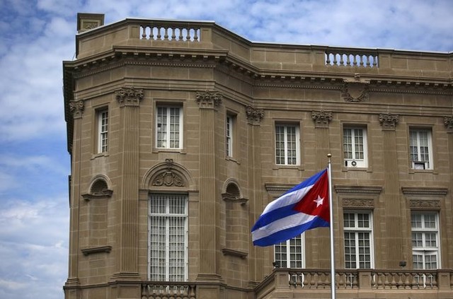 The Cuban national flag is seen raised over their new embassy in Washington July 20, 2015. Credit: Reuters