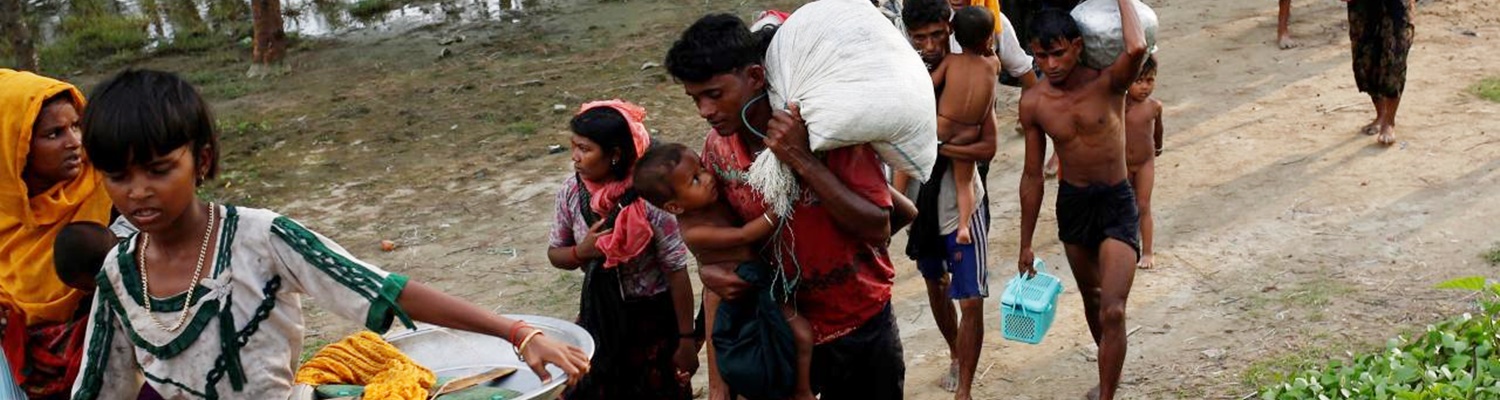 Rohingya refugees walk to the nearest village after crossing the Bangladesh-Myanmar border by boat through the Bay of Bengal in Teknaf, Bangladesh, September 5, 2017. REUTERS/Mohammad Ponir Hossain