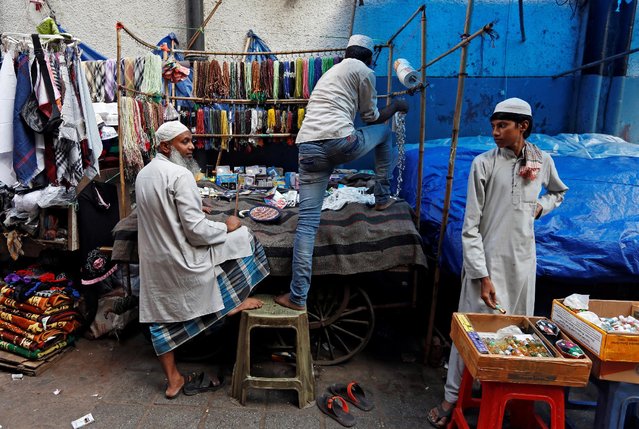 A street vendor sets up his stall outside the Nizamuddin Dargah in New Delhi. Credit: Reuters