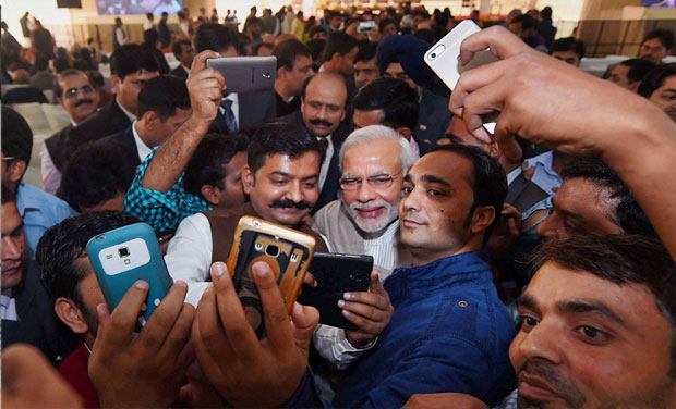 Prime Minister Narendra Modi poses for the selfies with reporters during the Diwali Mangal Milan at BJP headquarters in New Delhi. Credit: PTI/Files
