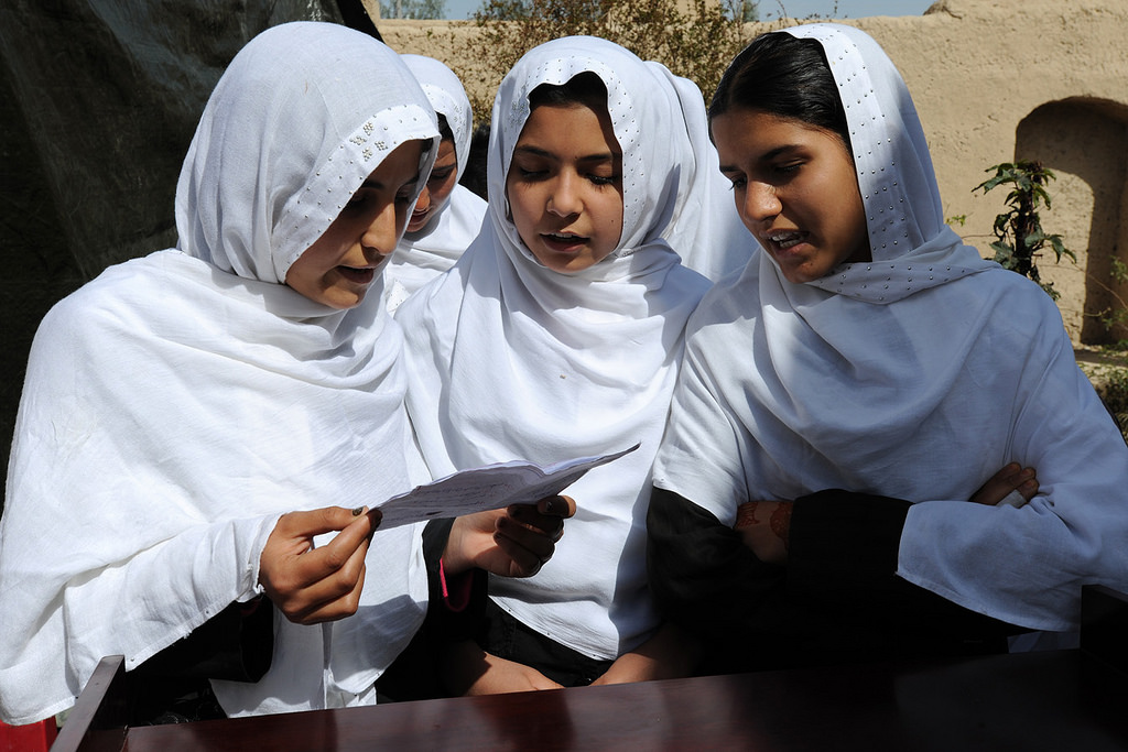 Students of the Farah Women’s Empowerment Center perform a song at the official dedication of the center, March 10, 2010, Farah, Afghanistan. Caption and credit: isafmedia/Flickr, CC BY 2.0