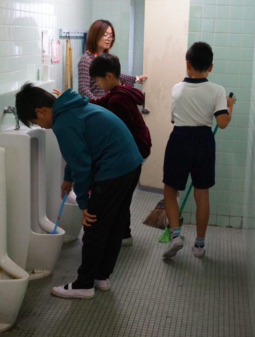 Boys cleaning a toilet at Kita-Yamada Elementary School in Osaka. Credit: Janaki Nair