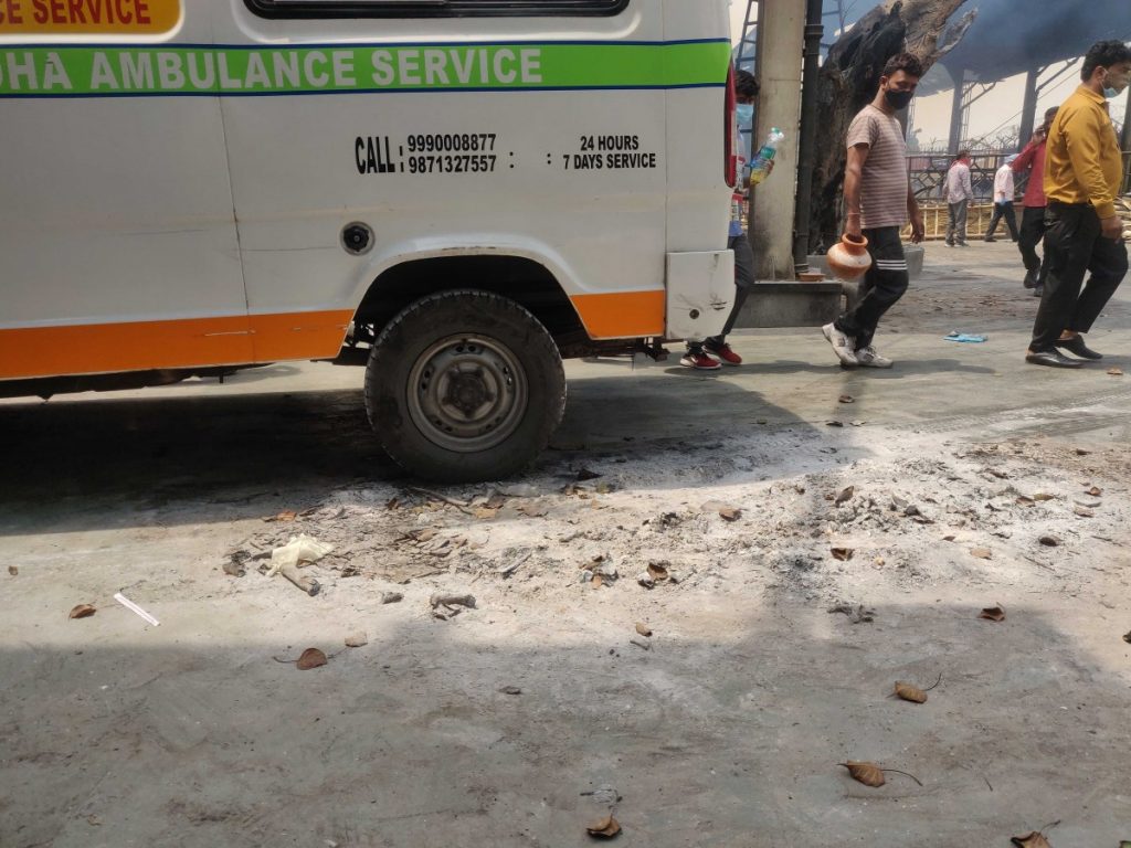 An Ambulance has run over a pile of ashes .