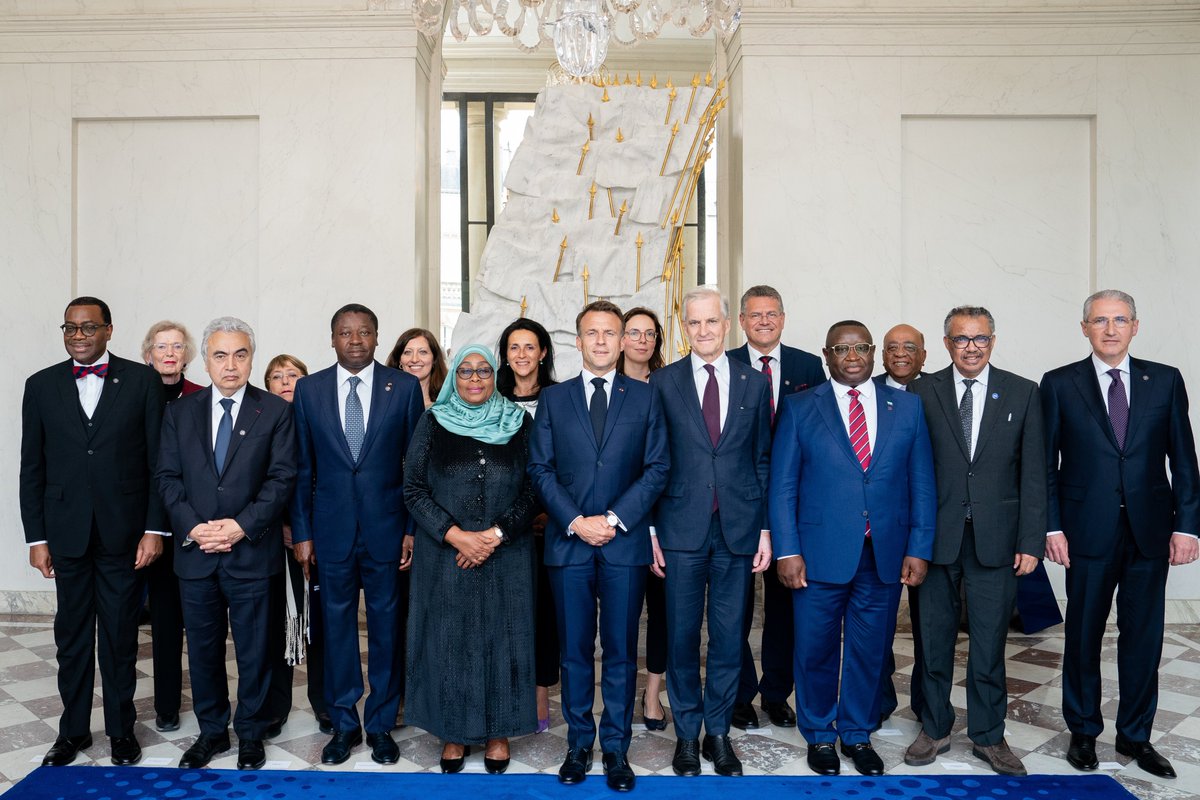French President Emmanuel Macron standing with leaders from the African Development Bank