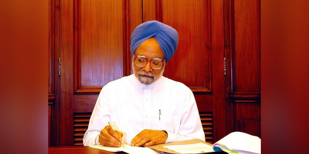 Manmohan Singh signs paperwork after taking oath as prime minister in 2004.