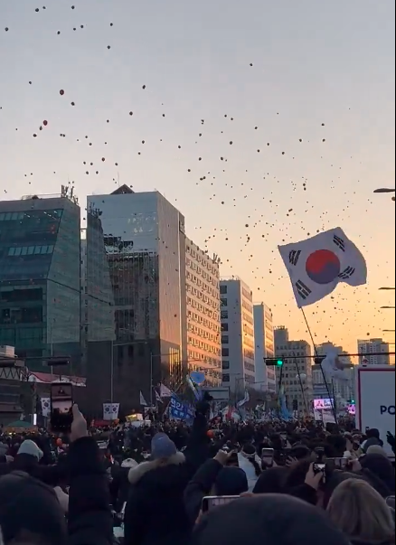 Screengrab from a video circulating on X showing South Koreans celebrating Yoon's impeachment