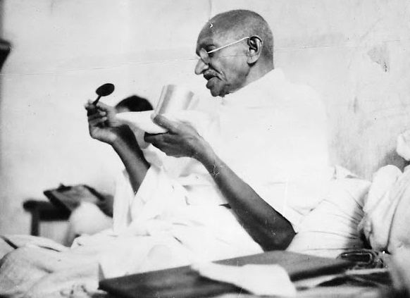 Mahatma Gandhi having a meal before beginning his last fast.