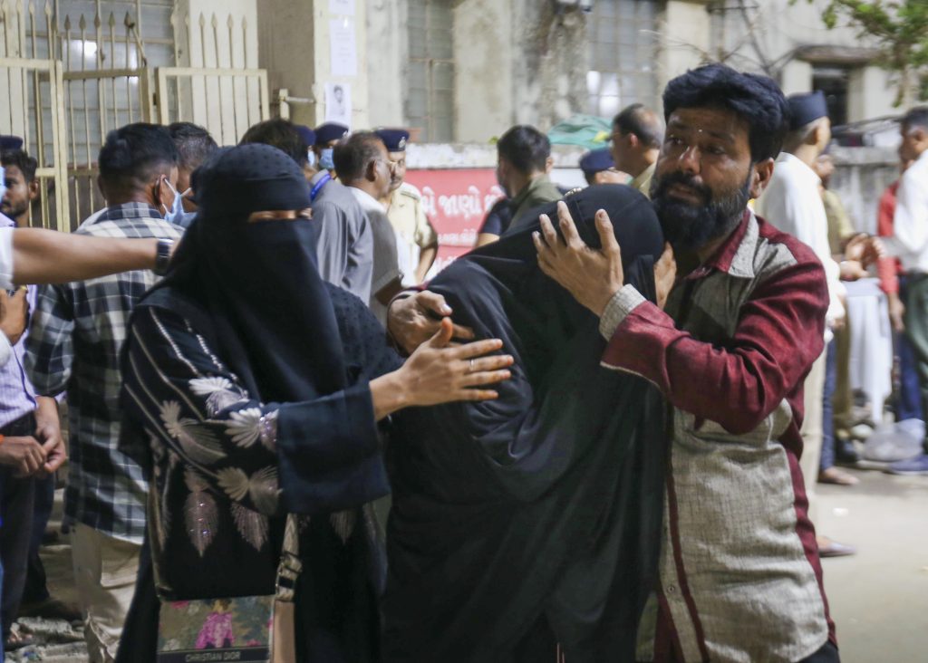 Relatives of a plane crash victim mourn their loss outside an Ahmedabad hospital.