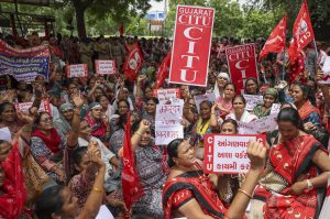 Members of various trade unions take part in a protest rally during a 24-hour nationwide general strike called by trade unions against the central government's alleged anti-labour policies, in Ahmedabad, Wednesday, July 9, 2025. 
