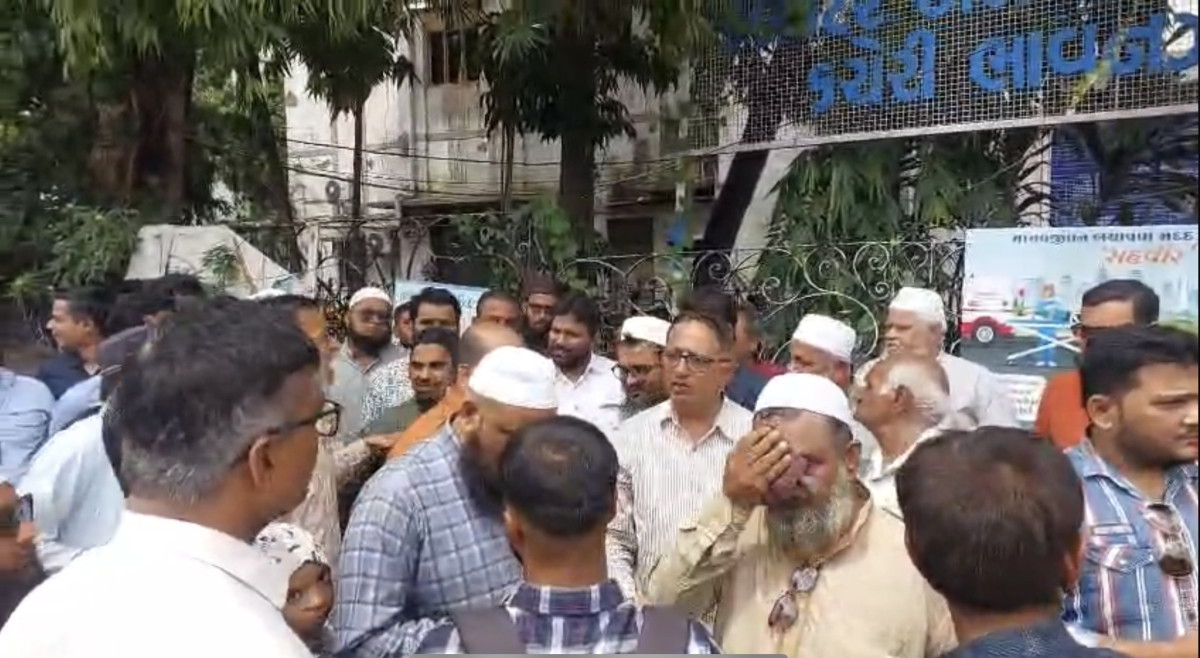 Locals from Muslim community gather outside the DEO office in Bhavnagar. 