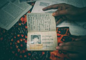 A family member showing the passport of Mohammad Ramzan Bhat, a shopkeeper who was detained and died in the custody of security forces in 1996. Photo: Ubaid Mukhtar
