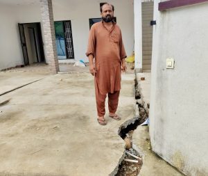 Javed Ahmad, a resident of Kheri, standing in the cracked compound of his house which has been damaged in land subsidence. Jehangir Ali/The Wire