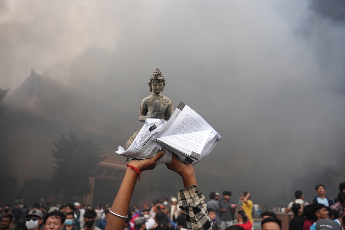 A protester holding up an idol of Gautam Buddha at the protest in Kathmandu, Nepal. Photo: AMIT MACHAMASI/Nepali Times.