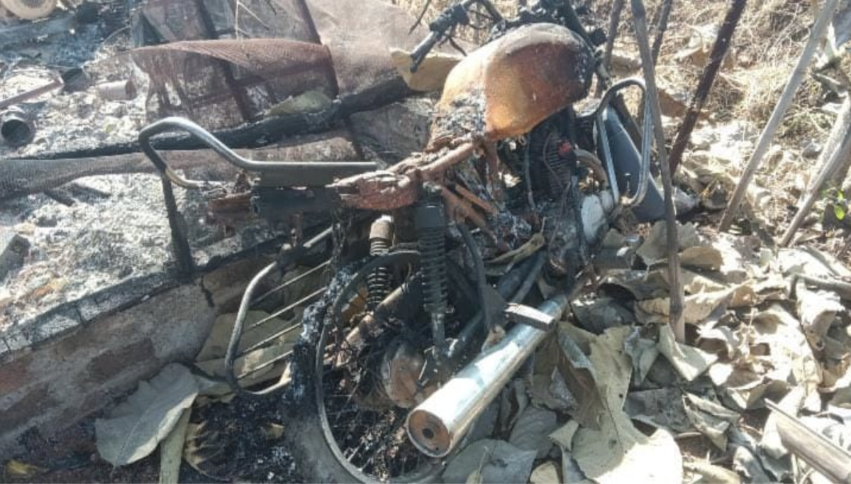 A bike in ashes after being engulfed in flames. Photo: The Wire