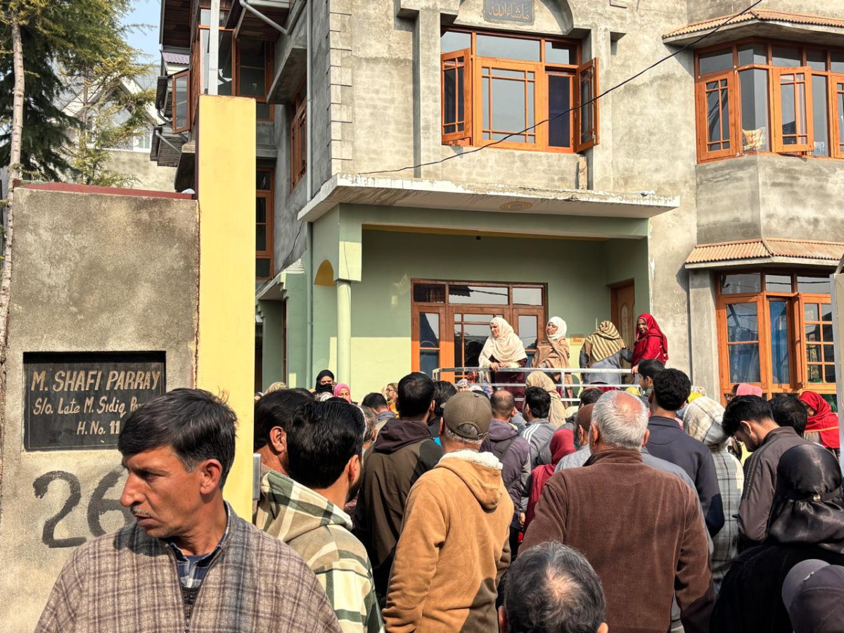 Relatives in front of the house of the tailor who died in Srinagar police station blast.