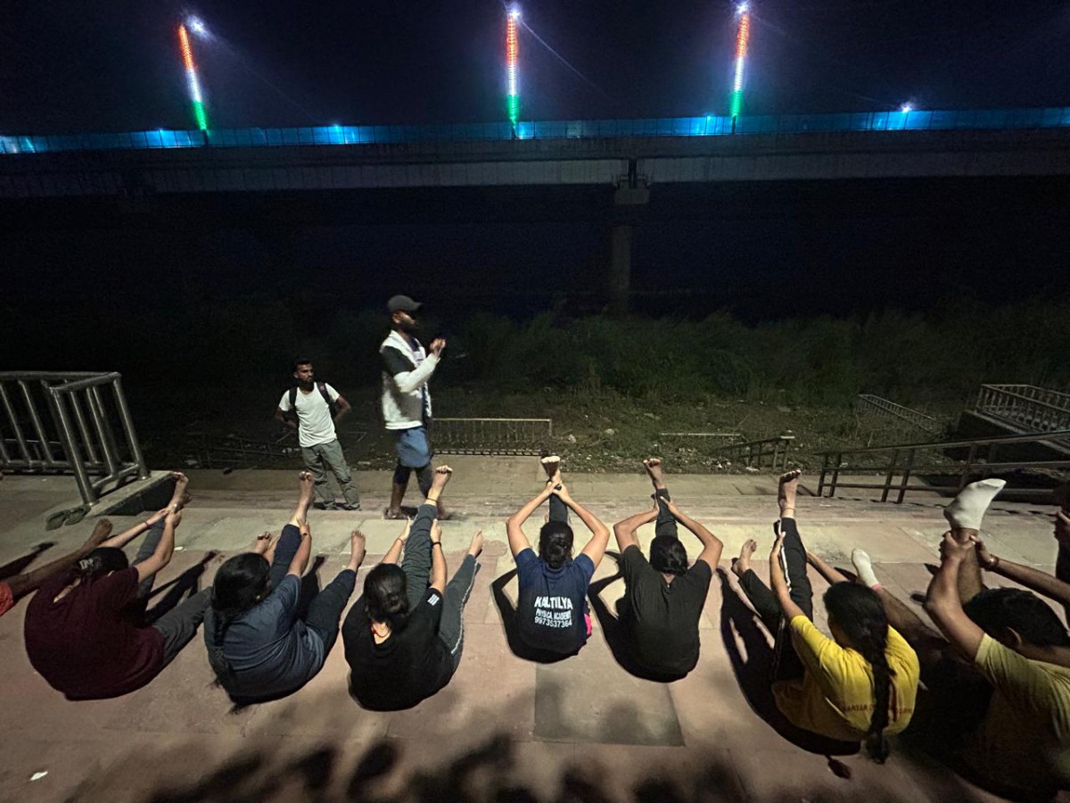 Bihar police job aspirants training on the bank of the Ganges in Patna.