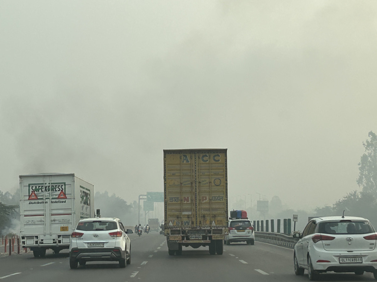 Cars on a Delhi road amid heavy smog in December.