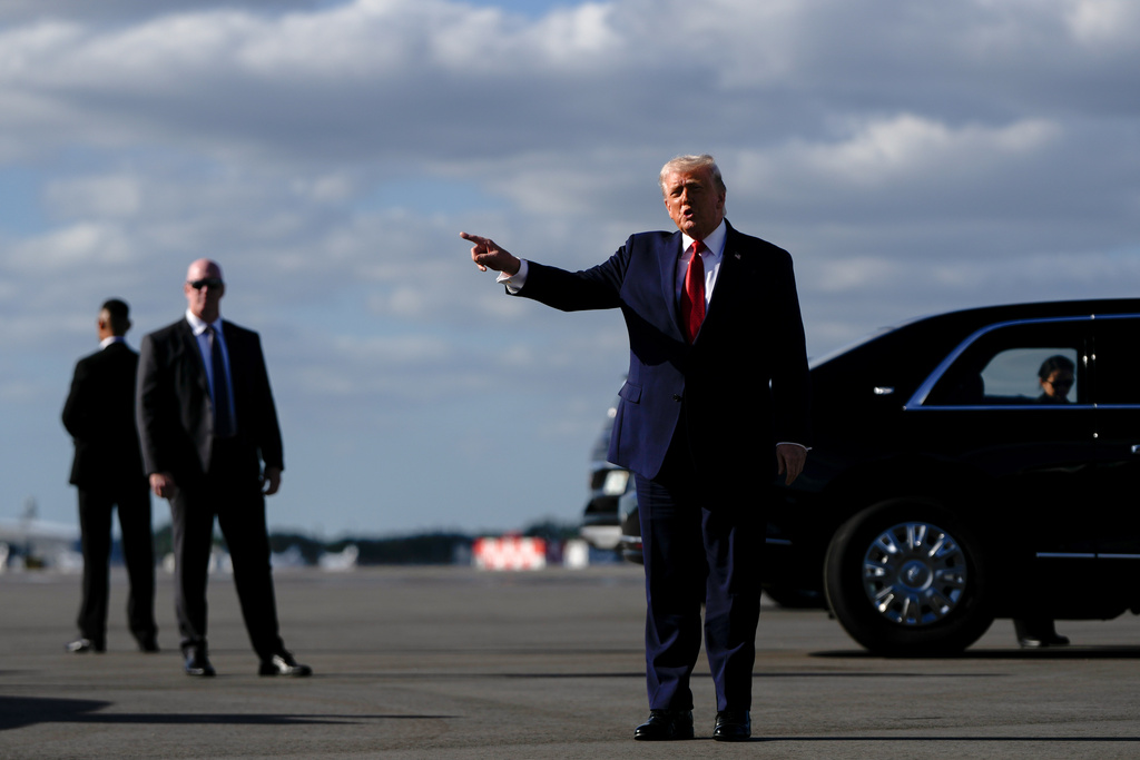President Donald Trump points after arriving at Palm Beach International Airport on Air Force One, Friday, Jan. 16, 2026, in West Palm Beach, Fla.