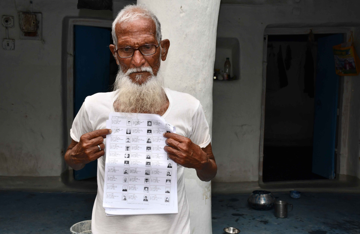 Elderly resident of Punisol village, Abdul Sabur Molla, shows his name marked Under Adjudication in the voter list.