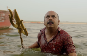 Detective Eken with the trident, stopping the terrorist (Source: YouTube) 