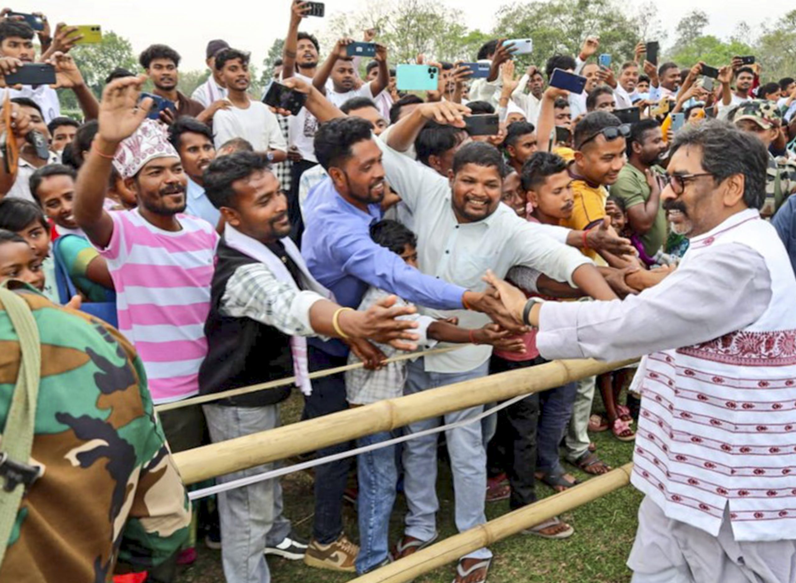 Hemant Soren greets people during a campaign rally in Assam.