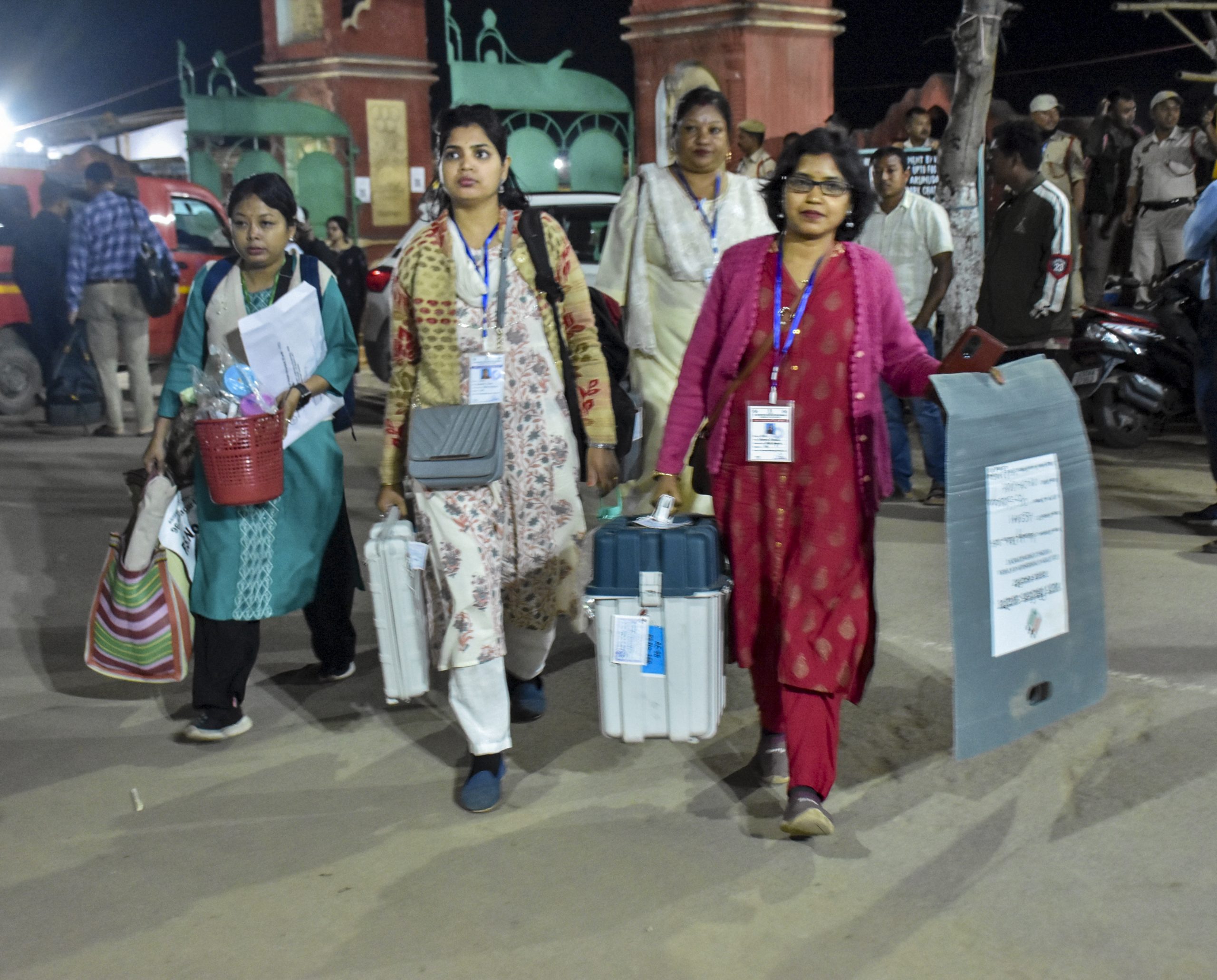 Officials with EVMs in Assam.