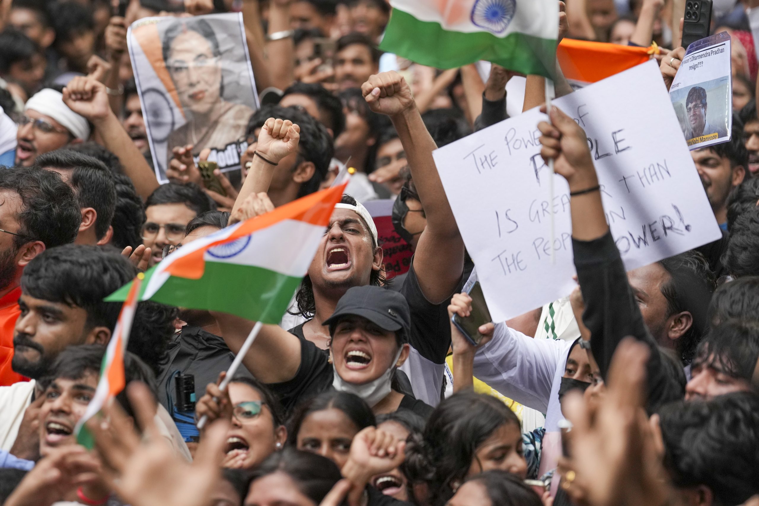 People hold placards as they take part in a protest march as part of the Cockroach Janata Party's (CJP) ongoing protest movement demanding the resignation of Union Education Minister Dharmendra Pradhan over the NEET paper leak issue, at Shivaji Park, in Mumbai, Friday, July 24. Photo: PTI