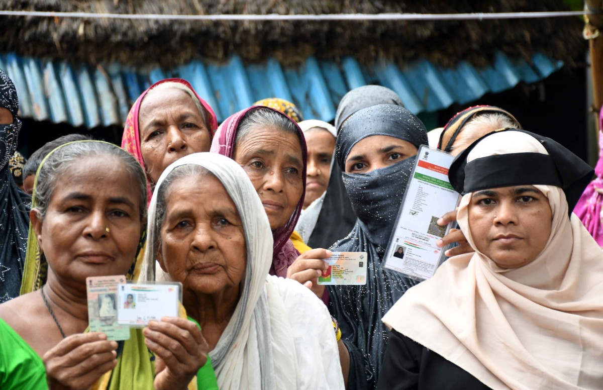 Residents of Mira mohalla showing their voter card. Photo: Madhu Sudan Chatterjee