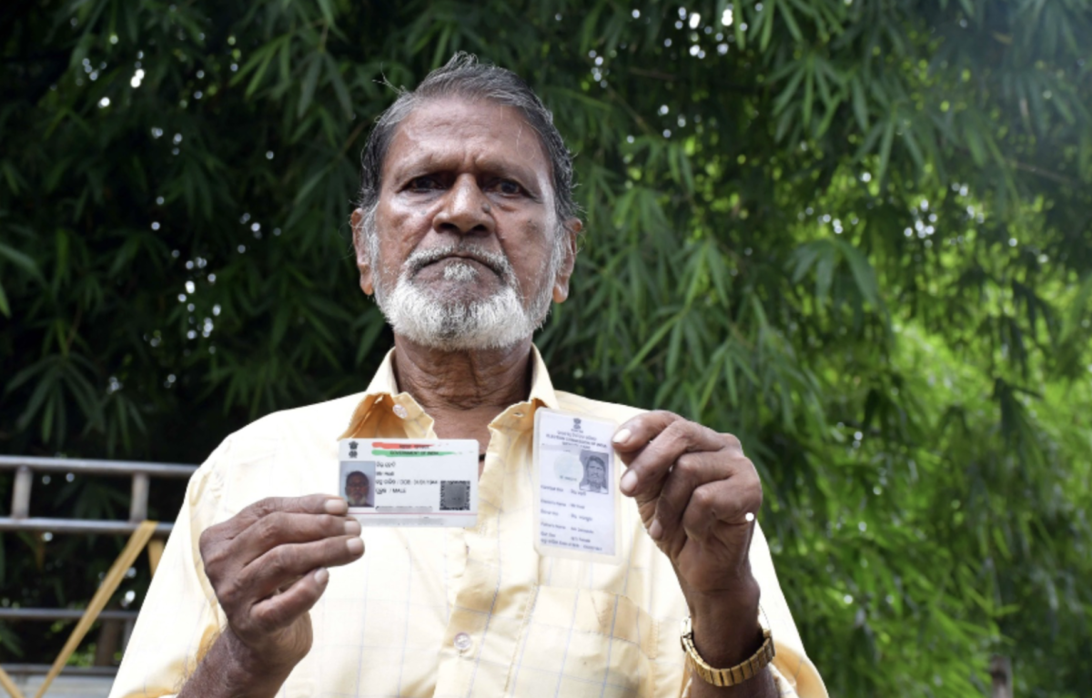 Mir Alam Gir, 85, a resident of Banka mohalla in Bhadrak, shows his Aadhaar and voter card.
